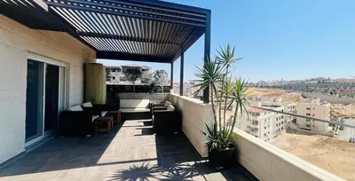 a balcony with a view of a building at An Overlooking Rooftop in Amman in Amman