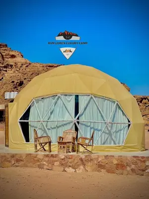 a dome tent with chairs in the desert at RUM LOREN lUXURY CAMP in Wadi Rum