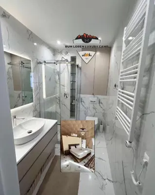 a bathroom with a sink and a mirror at RUM LOREN lUXURY CAMP in Wadi Rum