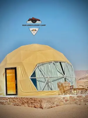 a large dome tent with chairs in the desert at RUM LOREN lUXURY CAMP in Wadi Rum