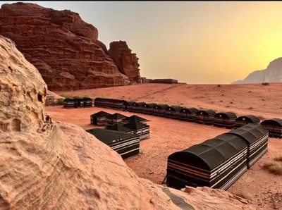 a group of train cars parked in the desert at Starlit Wadi Rum camp in Wadi Rum
