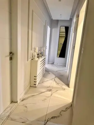 a hallway with a large marble floor in a building at Elegant & Cozy Apartment in Heart of Amman in Amman