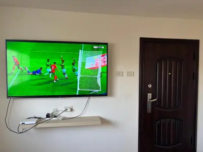 a flat screen tv hanging on a wall at Ash Shawbak Apartment in Umm Şawwānah