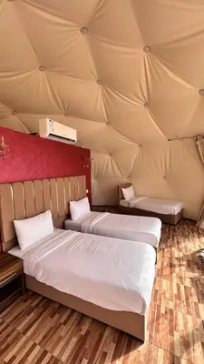 a room with two beds in a tent at Luxury Mars Camp in Wadi Rum