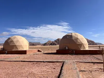 two domes sitting in the middle of the desert at Wadi Rum Desert Wonders Camp in Disah