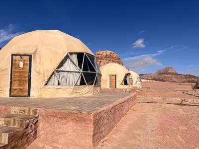 a couple of dome houses in the desert at Wadi Rum Desert Wonders Camp in Disah