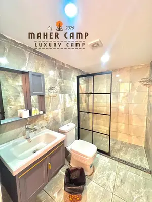 a bathroom with a toilet and a sink at Wadi rum maher luxury camp in Wadi Rum