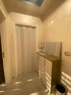 a small room with a door and a counter at studio apartment for rent in Amman