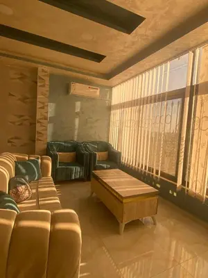a living room with a couch and a table at studio apartment for rent in Amman