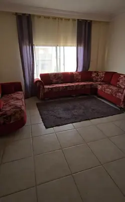 a living room with a couch and a window at عبدالرحمن الشطناوي in Aqaba