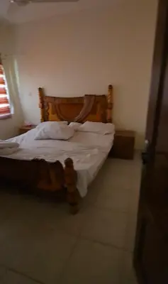 a bedroom with a bed with a wooden head board at عبدالرحمن الشطناوي in Aqaba