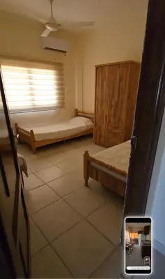 a room with two beds and a window at عبدالرحمن الشطناوي in Aqaba