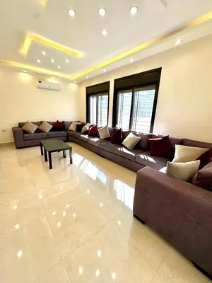 a large living room with couches and a table at Bright & Comfortable Villa in Abu Nuseir in Al Jafr