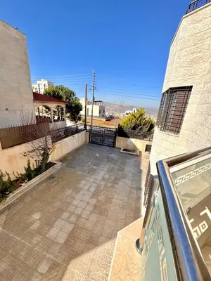 a view of a parking lot from a building at Bright & Comfortable Villa in Abu Nuseir in Al Jafr