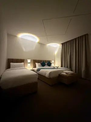 a hotel room with two beds and a window at شقق سلين الفندقية in Amman