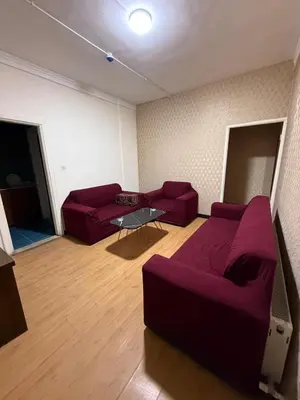 a living room with two red couches and a table at شقق سلين الفندقية in Amman