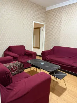 a living room with purple couches and a table at شقق سلين الفندقية in Amman