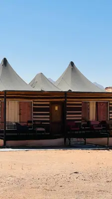 a building with large tents in the desert at RUM FIRAS lUXURY CAMP in Wadi Rum