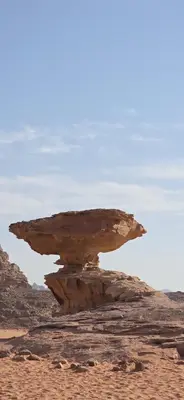 a rock in the middle of the desert at RUM FIRAS lUXURY CAMP in Wadi Rum