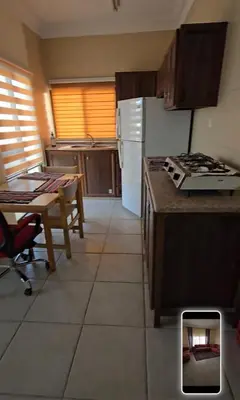 a kitchen with a table and a stove top oven at عبدالرحمن الشطناوي2 in Aqaba