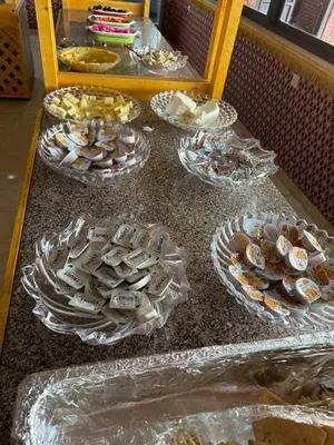 a table with several trays of cookies and other desserts at TAJ luxury Camp in Wadi Rum