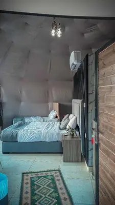 a bedroom with a bed in a room at TAJ luxury Camp in Wadi Rum