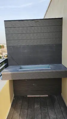 a bench with a hot tub on top of a building at LaPerla Rooftop family in Amman