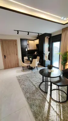 a living room with tables and chairs in a room at LaPerla Rooftop family in Amman
