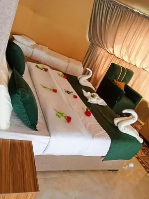 a bed with green and white towels on it at DESERT PULSE lUXURY CAMP in Wadi Rum
