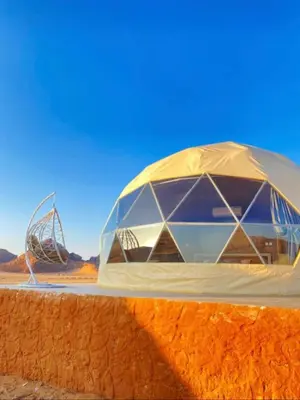 a domed building in the middle of the desert at Essam camb in Disah