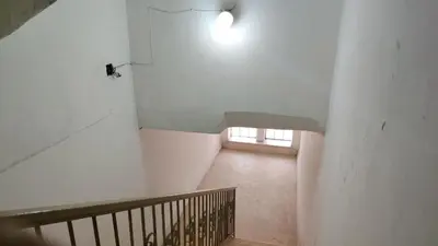 a hallway with a staircase with a window in a building at Stone house in Amman