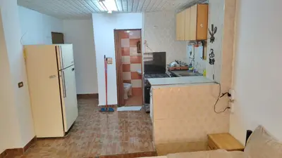 a kitchen with a refrigerator and a counter top at Stone house in Amman