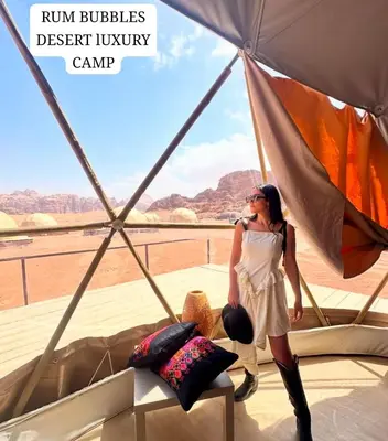a woman standing inside a yurt in a desert turkey camp at RUM BUBBLES DESERT lUXURY CAMP in Wadi Rum