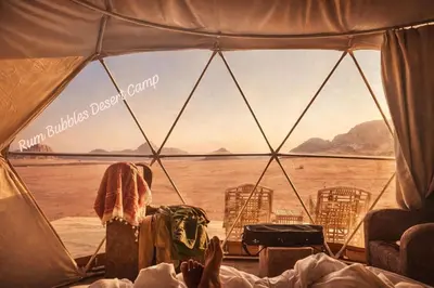 a view from inside a tent looking out at the water at RUM BUBBLES DESERT lUXURY CAMP in Wadi Rum