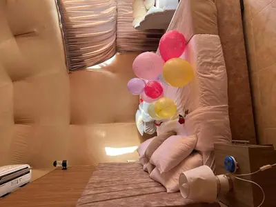 a group of balloons on a bed in a room at Wadi Rum Main Road Visitor Center in Disah
