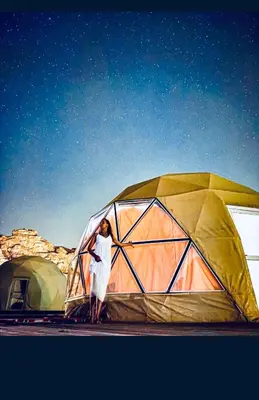 a woman standing in front of a tent at Wadi Rum Main Road Visitor Center in Disah