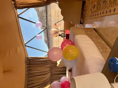 a group of balloons in a room with a window at Wadi Rum Main Road Visitor Center in Disah
