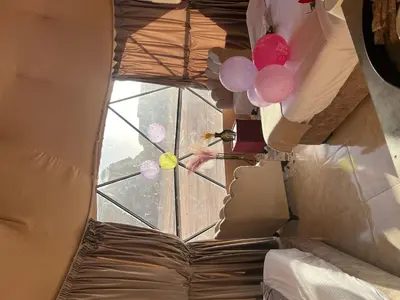 a view of a window with balloons in a room at Wadi Rum Main Road Visitor Center in Disah