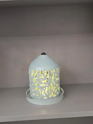 a cake on a plate on a shelf at Two-bedroom family friendly modern apartment in Amman