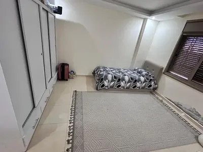a room with a couch in a room with a window at Irbid in Nāţifah