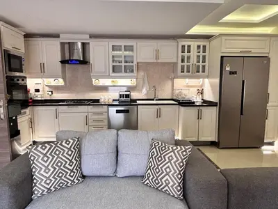 a living room with a couch and a kitchen at Irbid in Nāţifah