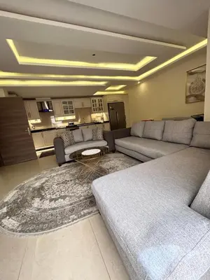 a living room with a couch and a rug at Irbid in Nāţifah