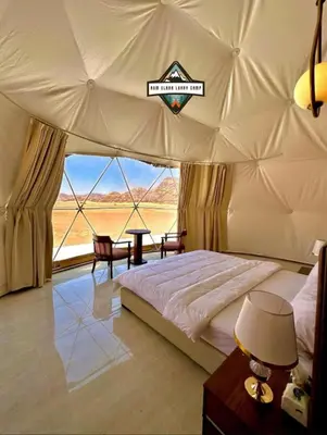 a bedroom with a large bed in a tent at RUM ELARA lUXRY CAMP in Wadi Rum