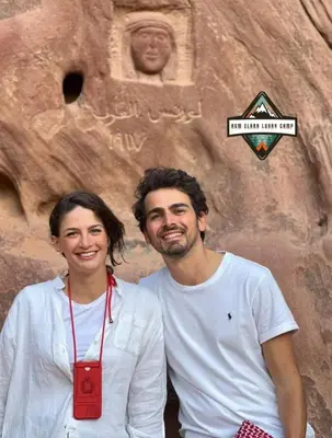 a man and a woman standing in front of a statue at RUM ELARA lUXRY CAMP in Wadi Rum