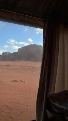 a view of the desert from a window of a tent at Bedouin Whispers Camp wadirum in Wadi Rum
