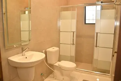 a bathroom with a toilet and a sink and a shower at شقة مفروشة مع ساحة خارجية قرب دوار اليوسفي in Irbid