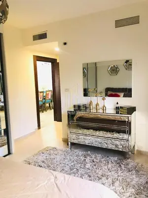 a bathroom with a large mirror and a rug at Chic 2-Bedroom - Fully Furnished in Amman
