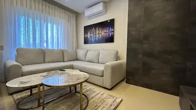 a living room with a couch and a table at Modern Apartment in Um Uthaina Amman in Amman
