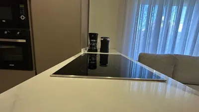 a counter top with two bottles on top of it at Modern Apartment in Um Uthaina Amman in Amman
