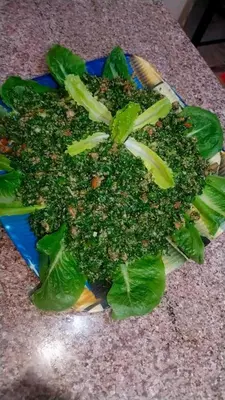 a pile of broccoli on a blue plate on a counter at غبار الطلح هاوس in Ma‘ān